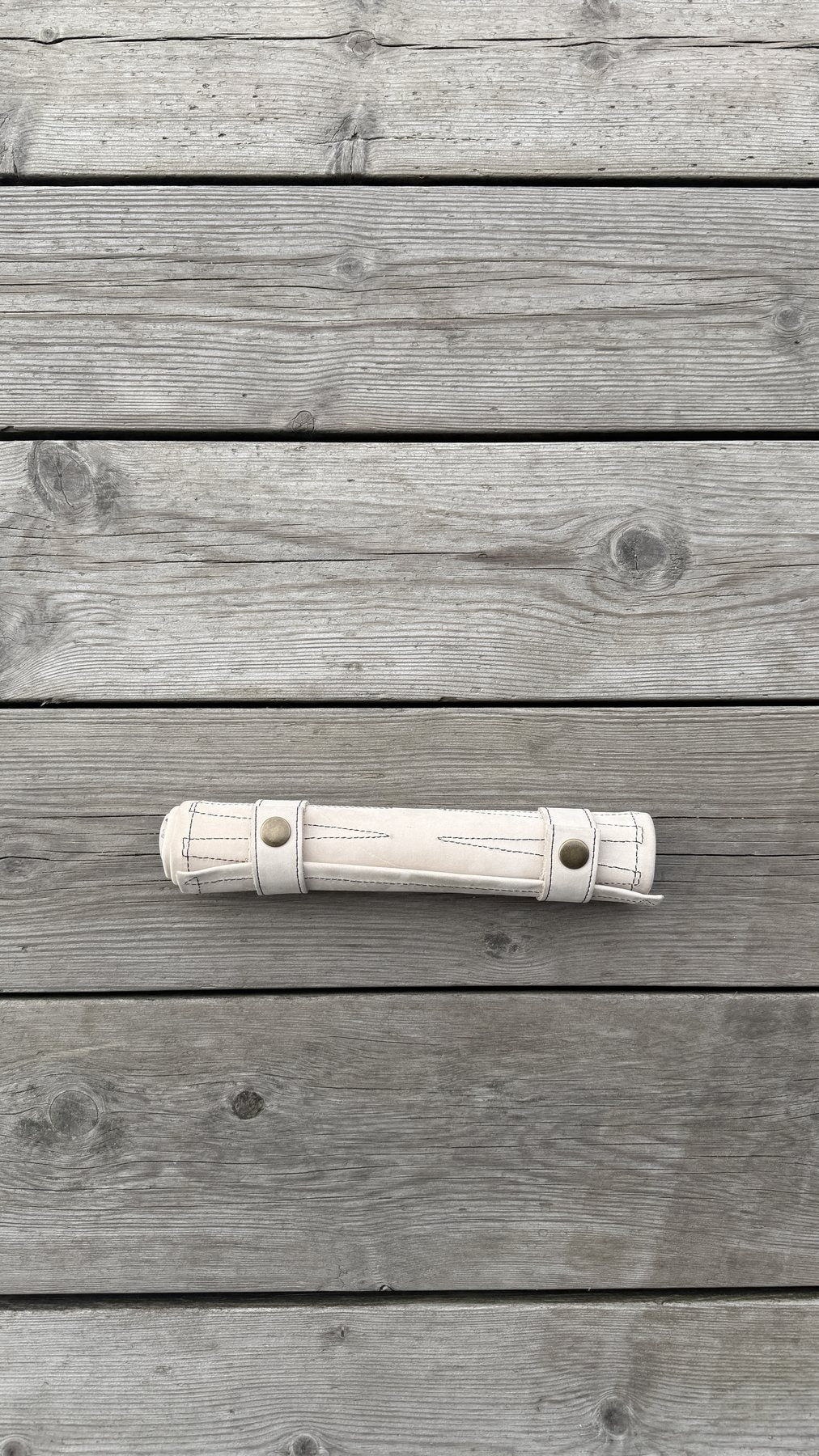 Light Beige suede backgammon set rolled for travel