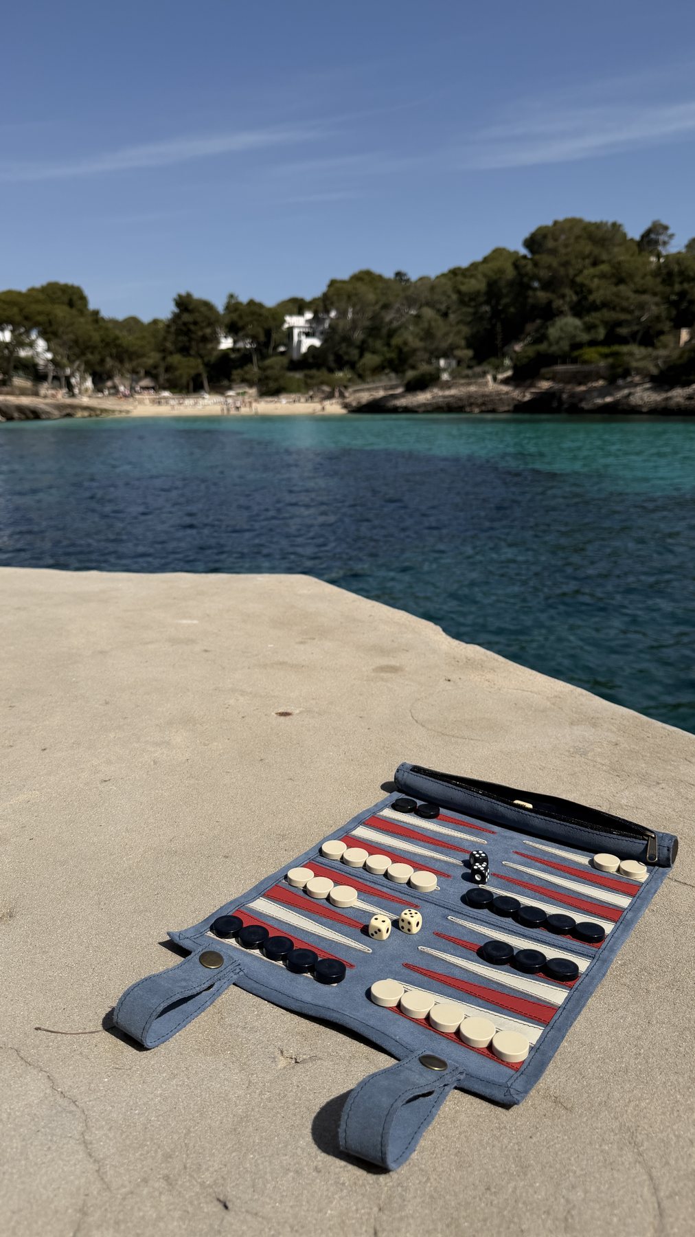 Ocean Blue suede backgammon set rolled for travel